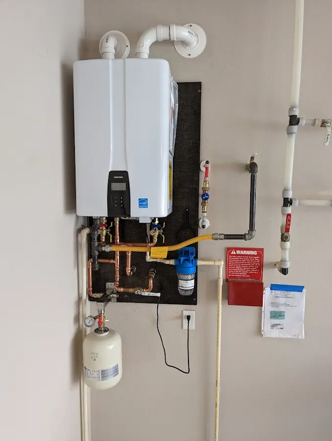 Professional plumber installing copper piping in a Junction City home